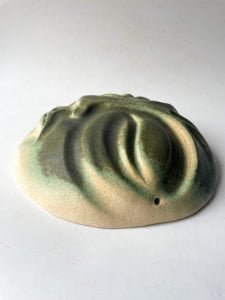 green ceramic moon sculpture