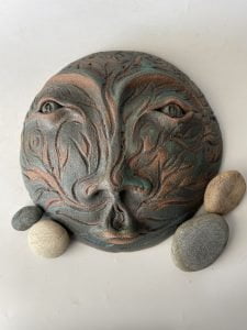 ceramic face garden art